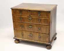 AN 18TH CENTURY WALNUT CHEST OF DRAWERS, with decoratively veneered top and drawers, boxwood