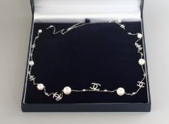 A CHANEL PATTERN SILVER, PEARL AND CZ LONG NECKLACE.
