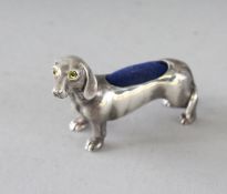 A SILVER DACHSHUND DOG PIN CUSHION. 2ins.