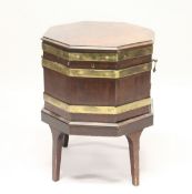 A GEORGE III MAHOGANY AND BRASS BOUND OCTAGONAL CELLARETTE , on tapering square legs. 1ft 8ins