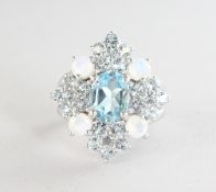 A SILVER, BLUE TOPAZ AND MOONSTONE RING.