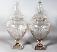 A GOOD LARGE PAIR OF CRYSTAL CUT SWEET JARS AND COVERS on square stepped bases. 21ins high.