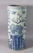 A CHINESE BLUE AND WHITE UMBRELLA STAND, dragon decoration. 24ins high.