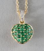 AN 18CT GOLD, EMERALD AND DIAMOND HEART SHAPED PENDANT on a chain.