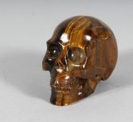 A TIGER'S EYE SKULL. 3.5ins.