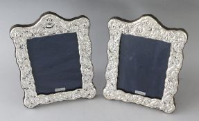 A PAIR OF SILVER PHOTOGRAPH FRAMES. 7.5ins x 5.5ins.
