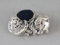 A SILVER SLEEPING CAT PIN CUSHION. 1.25ins