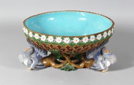 A MINTON MAJOLICA CIRCULAR BOWL, the sides with green lattice work and oak leaves, supported by