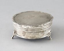AN ENGLISH TURNED SILVER CIRCULAR RING BOX on three hoof feet. 3ins diameter. Birmingham 1914.