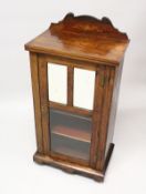 A VICTORIAN ROSEWOOD MUSIC CABINET, with a mirrored and glazed single door, on a plinth base with