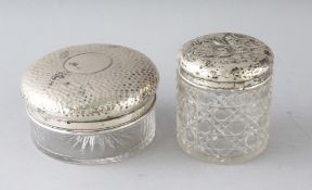 A HAMMERED SILVER CIRCULAR GLASS PIN BOX with silver top, 3.75ins diameter, Birmingham 1910, and a