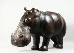 A GOOD LEATHER HIPPOPOTAMUS STOOL OF LARGE SIZE, Probably for LIBERTY & CO. 39ins long x 20ins