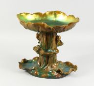 AN UNUSUAL CONTINENTAL LUSTRE GLAZED POTTERY CENTREPIECE, modelled as a tree stump with moulded