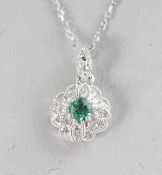 AN 18CT WHITE GOLD, EMERALD (0.11cts) AND DIAMOND (0.09cts) VINTAGE PENDANT on a chain.