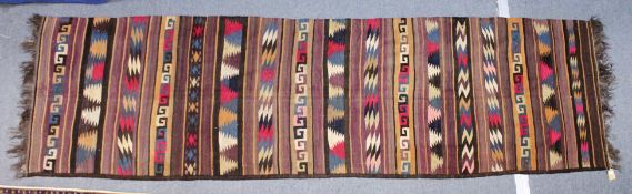 A FLATWEAVE KELIM RUNNER/HALL CARPET, with bands of Greek key and other geometric designs. 13ft 0ins