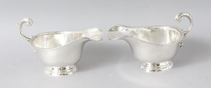 A PAIR OF SILVER BEAD EDGE SAUCEBOATS. London 1936.