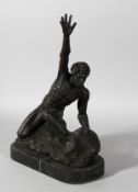 A BRONZE MALE NUDE, arm raised, on a marble base. 14ins high.