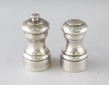 A PAIR OF SILVER PEPPER MILLS.