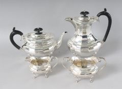 A FOUR PIECE SILVER TEA SET, comprising teapot, hot water jug, sugar basin and milk jug.