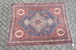 A GOOD SMALL QASHQAI RUG, early 20th century, cream ground central panel, stylised palmette design