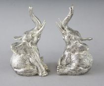 A PAIR OF CAST 800 SEATED ELEPHANT SALT AND PEPPERS. 3.25ins high.