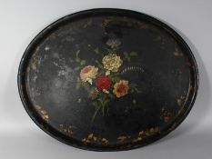 A VICTORIAN OVAL PAPIER MACHE TRAY, painted with a floral spray. 28.5ins wide.