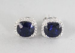 A SUPERB PAIR OF 18CT WHITE GOLD CUSHION SAPPHIRE, 4.51CTS, AND DIAMOND HALO EARRINGS, 0.26CTS.