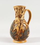 A DOULTON STONEWARE JUG by FRANK BUTLER, with leaves in relief. Maker F.A.B. 7.5ins high (AF).