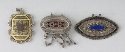THREE SILVER ENGRAVED PENDANTS.