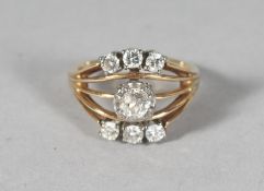 A GOLD AND SEVEN-STONE DIAMOND RING.