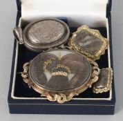 THREE VARIOUS VICTORIAN BROOCHES inset with hair and a silver locket (4).