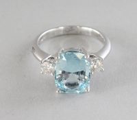 AN 18CT GOLD, AQUAMARINE AND DIAMOND THREE-STONE RING.