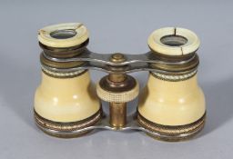 AN IVORY CASED PAIR OF OPERA GLASSES. 2.25ins, closed.