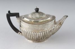 A VICTORIAN OVAL HALF FLUTED TEAPOT with ebony handle. London 1893. Weight 15ozs.