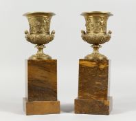 A SUPERB PAIR OF REGENCY BRONZE TWO-HANDLED URNS on marble stands. 9.5ins overall.