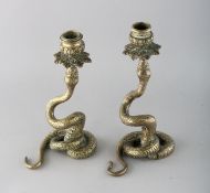 A PAIR OF BRASS SERPENT CANDLESTICKS. 8.5ins high.