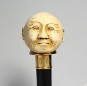 A GOOD WALKING CANE with carved ivory handle, head of a man, named on gilt band F. M. Camylon,