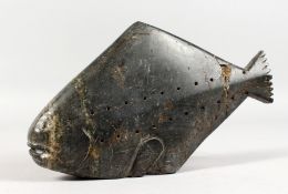AN INUIT CARVED HARDSTONE GROUP OF A FLAT FISH. Etched on base E 9-78 78. 10.5ins long.