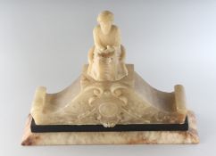 AN ALABASTER CLOCK surmounted by a TURK. 14ins long.