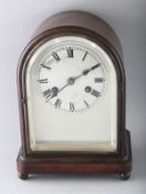 A 1930'S-1940'S MAHOGANY MANTLE CLOCK, with silvered dial on four bun feet. 11ins high.