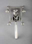 A SILVER AND MOTHER-OF-PEARL TEDDY ON A SWING RATTLE.