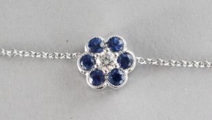 AN 18CT GOLD, SAPPHIRE AND DIAMOND CIRCULAR PENDANT ON CHAIN.