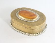 A BRASS OVAL SNUFF BOX with inset hardstone top. 2.75ins.