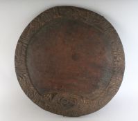 A 19TH CENTURY CARVED WOOD CIRCULAR PLATTER. 16ins diameter.