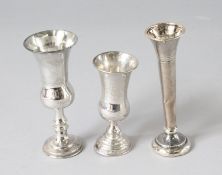 THREE SILVER MINIATURE VASES.