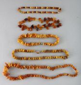 FIVE VARIOUS AMBER TYPE NECKLACES.
