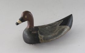 A CARVED WOOD AND PAINTED DECOY DUCK. 8ins long.