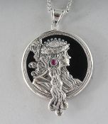 AN ART NOUVEAU DESIGN RUBY SET SILVER MUCHA PENDANT on a chain.