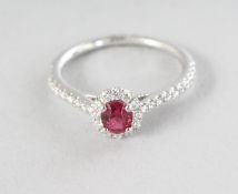 A WHITE GOLD OVAL SPINEL (0.48cts) PAVE DIAMOND (0.32cts) RING.