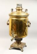 A LARGE 19TH CENTURY RUSSIAN BRASS SAMOVAR with carrying handles on square base with curving feet.